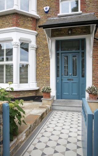 Victorian house with tiled front path leading to a blue painted door