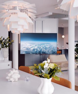 Modern white kitchen showcasing a TV ceiling mount