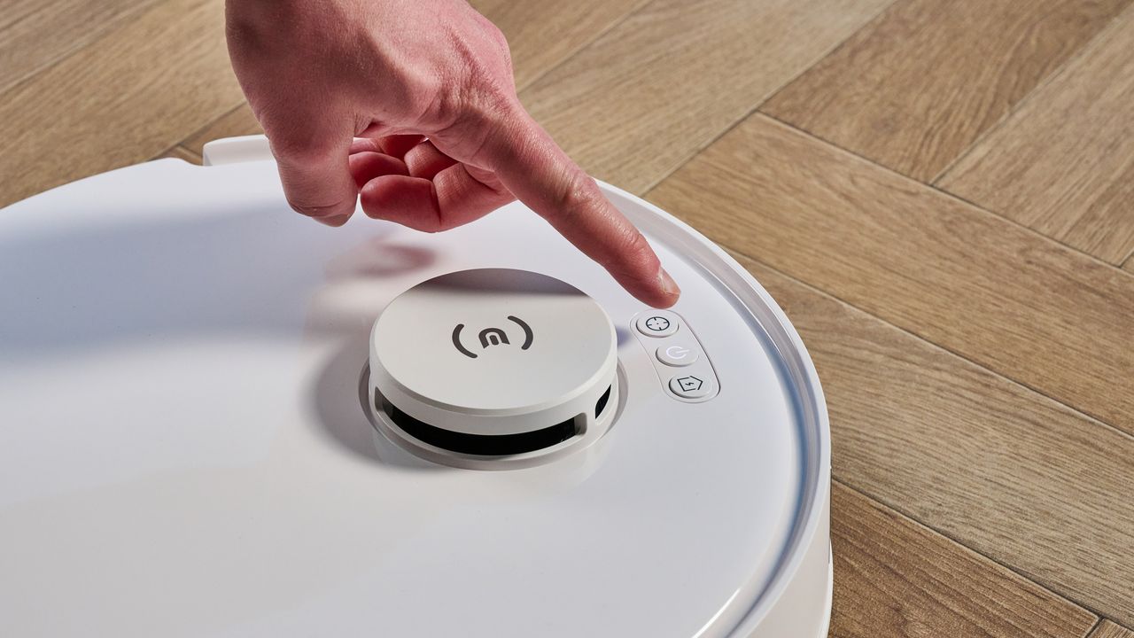 Ecovacs Deebot N20 in white photographed vacuuming floor
