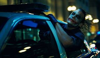 The Dark Knight Heath Ledger The Joker leans his head out of a cop car's window