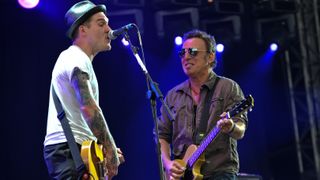 Bruce Springsteen performs on stage with Brian Fallon of The Gaslight Anthem on the last day of Hard Rock Calling 2009 in Hyde Park on June 28, 2009 in London, England