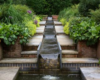 rill built into stone steps running down a gradient in a garden