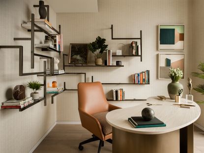 Home office setup with leather chair, curved desk and shelving