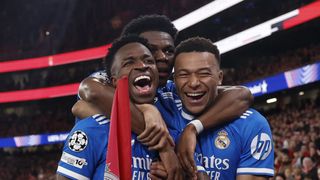 Vinicius Junior of Real Madrid celebrates with his teammates after scoring a goal during the UEFA Champions League 2025/26 League Knockout Play-off First Leg match between SL Benfica and Real Madrid C.F. at Estadio do SL Benfica on February 17, 2026 in Lisbon, Portugal. 
