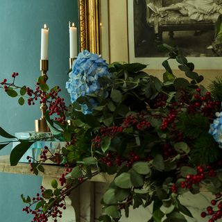 green dining room with fireplace and Christmas garland