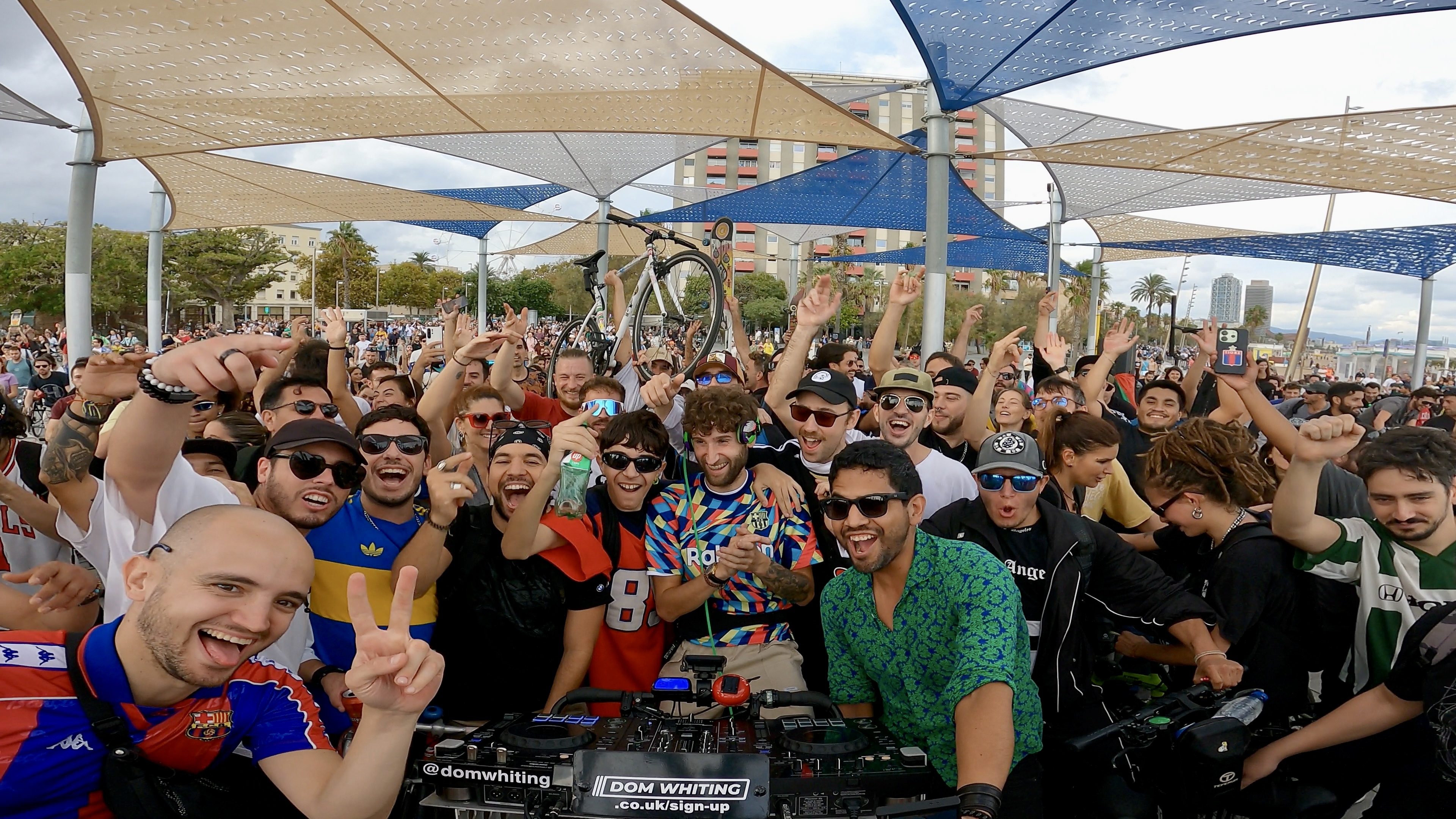 A crowd of people gather round Dom