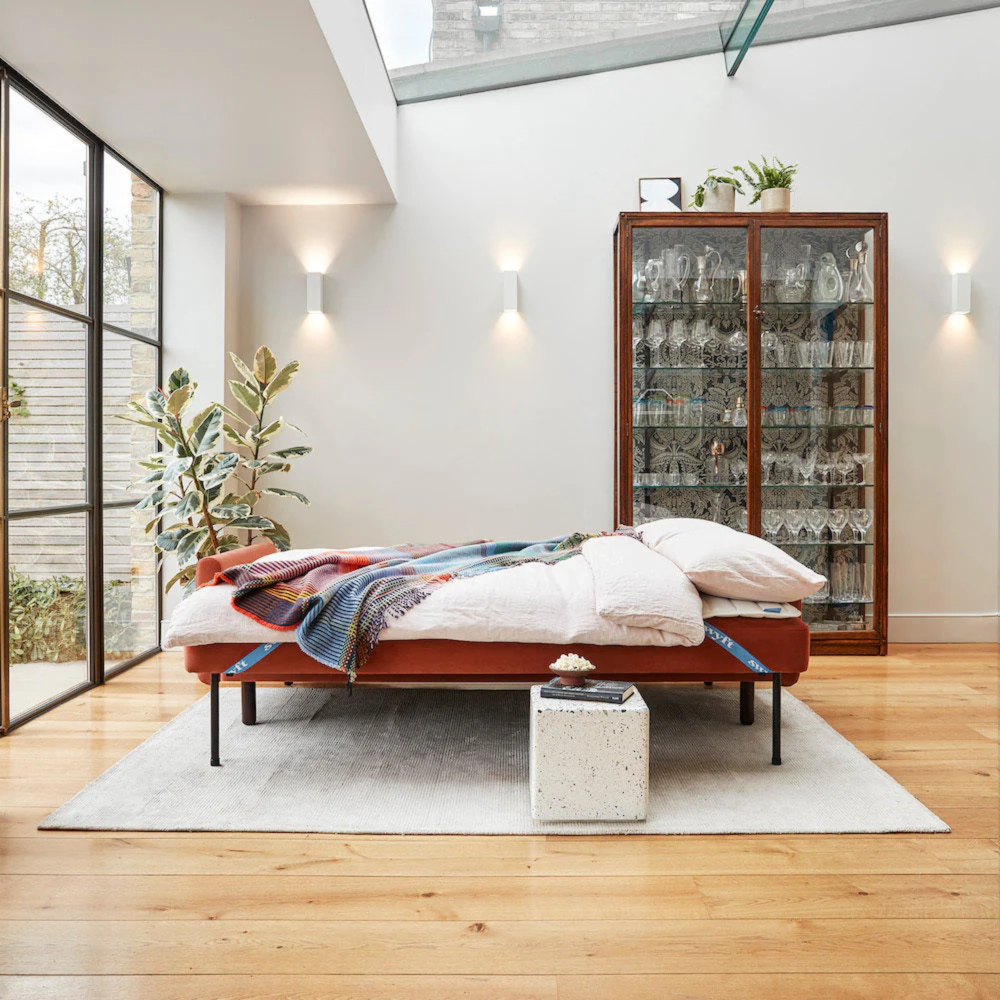 a sofa bed laid out in a modern extension