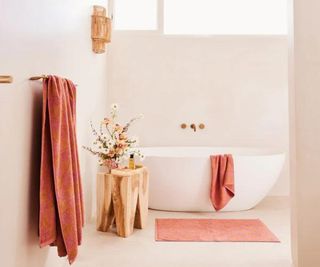 Terracotta linen towels hanging in a bathroom.
