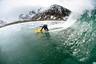 Dramatic surfing shot by Chris Burkard