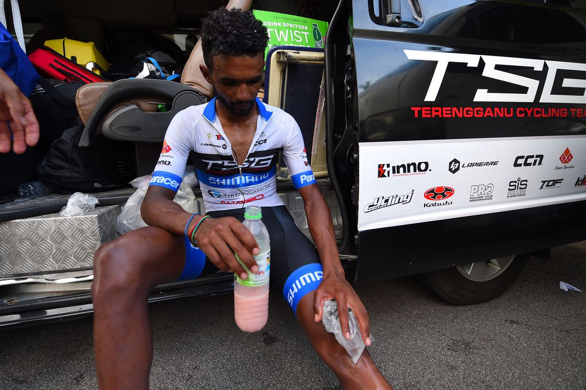 Metkel Eyob (Terengganu) tends to his injured knee after crashing early in the stage