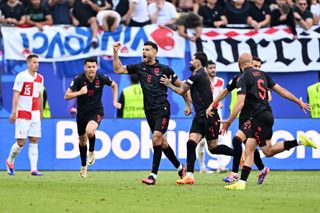 Klaus Gjasula of Albania celebrates scoring his team's second goal with teammates during the UEFA EURO 2024 group stage match between Croatia and Albania at Volksparkstadion on June 19, 2024 in Hamburg, Germany. (Photo by Dan Mullan/Getty Images)