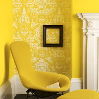 yellow chair against wall