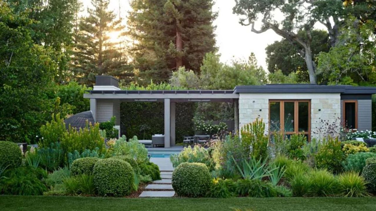 The backyard of a modern style bungalow, complete with a covered patio