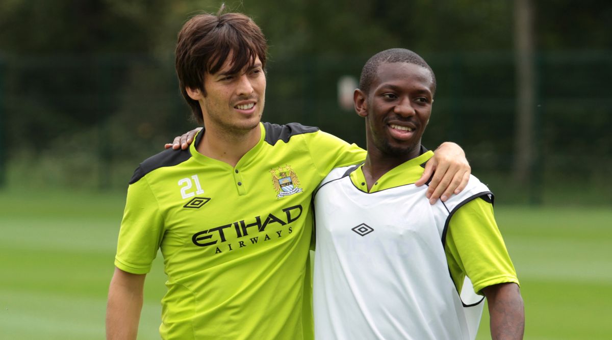 David Silva and Shaun Wright-Phillips standing arm-in-arm during a Manchester City training session in August 2011.