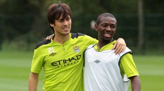 David Silva and Shaun Wright-Phillips standing arm-in-arm during a Manchester City training session in August 2011.