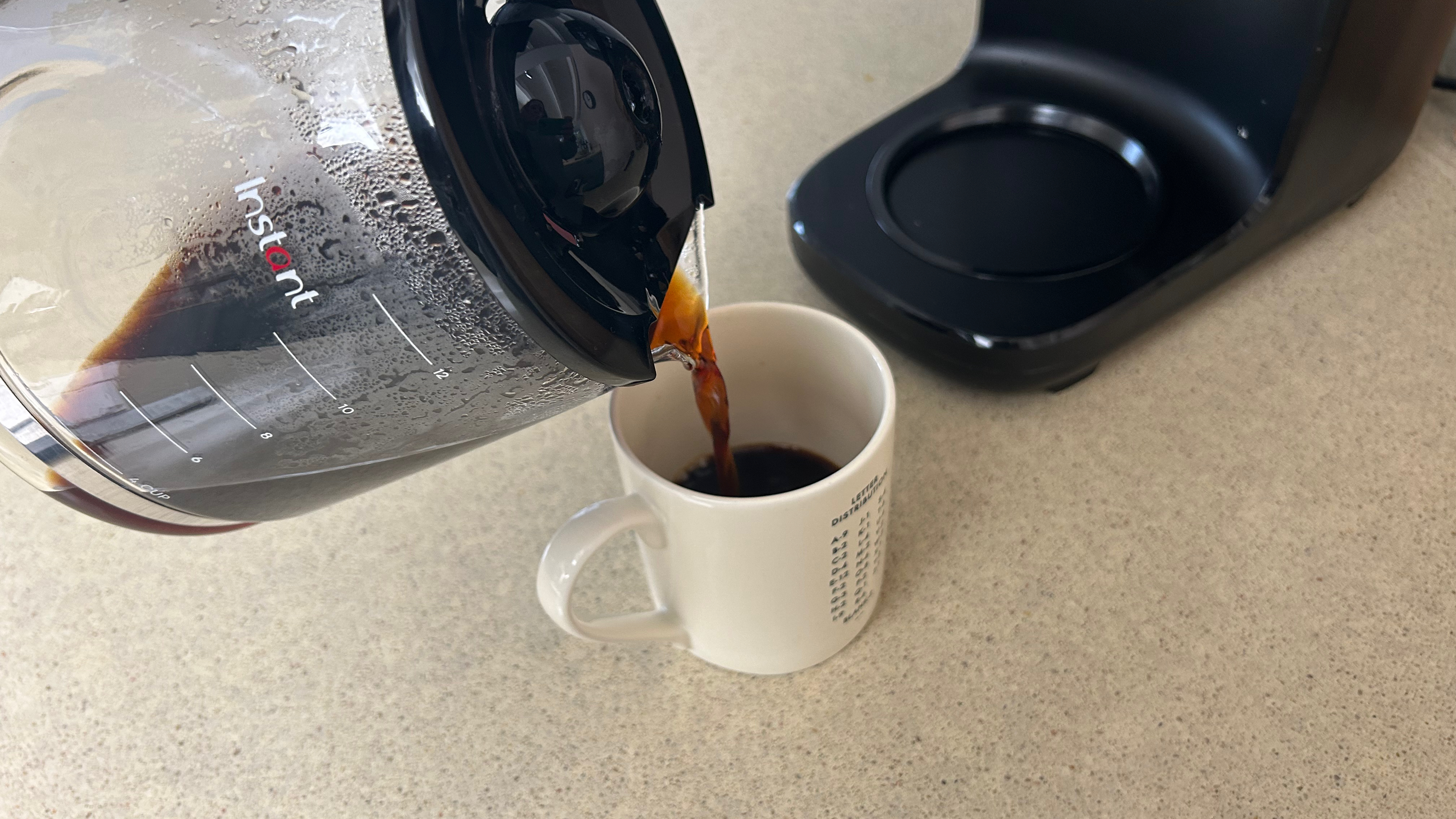 Pouring a cup of coffee from the Instant Infusion Brew jug