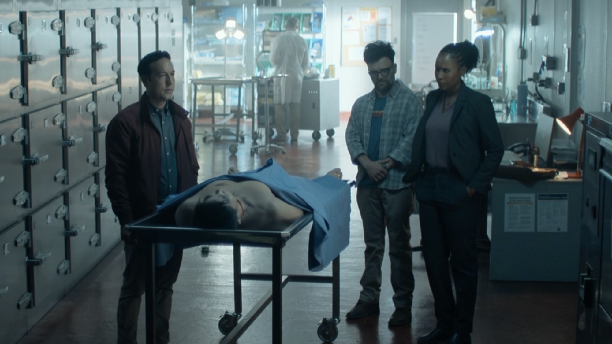 Tamara, Jacob and Russell all standing around Ben's corpse in morgue in Reacher Season 4