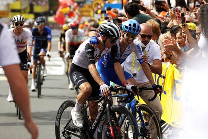 Simon and Adam Yates embrace at the 2023 Tour de France