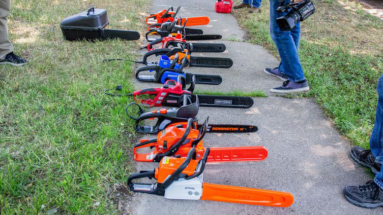 Best chainsaws: An image of several chainsaws lined up next to each other on a stone path