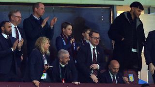 Prince William, Prince of Wales and Prince George of Wales look on alongside Tyrone Mings of Aston Villa during the UEFA Europa Conference League 2023/24 Quarter-final first leg match between Aston Villa and Lille OSC