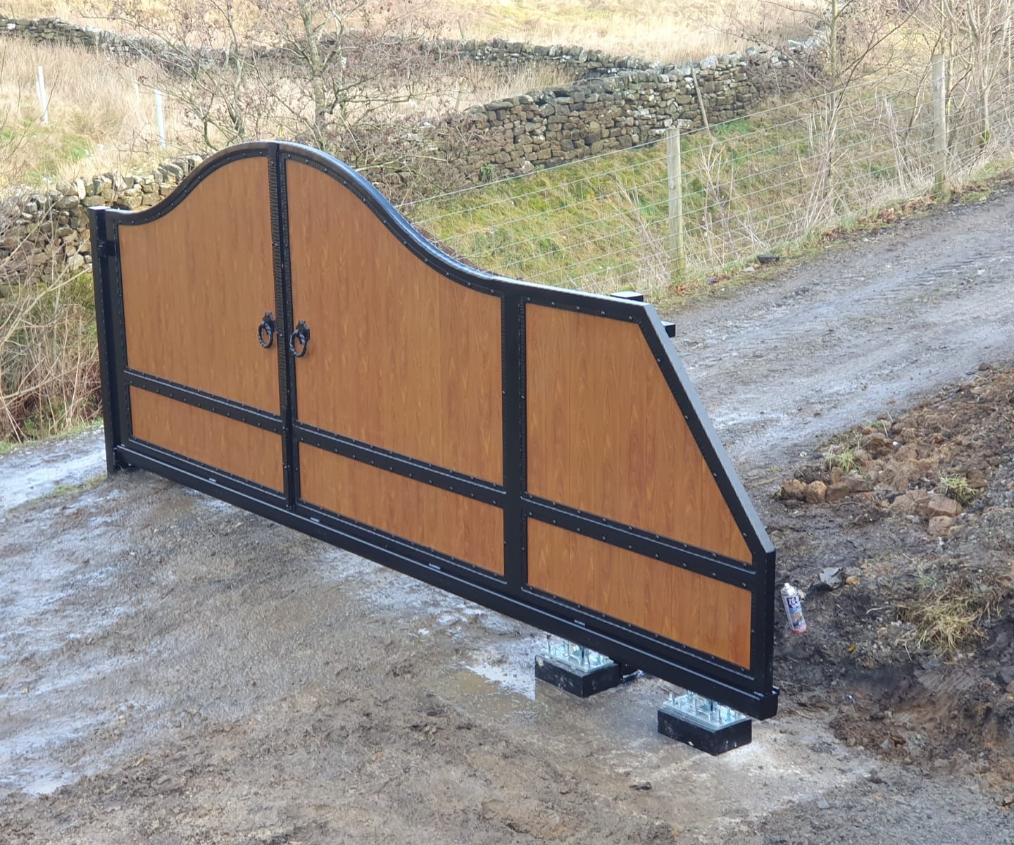 A North Valley Forge cantilever sliding electric driveway gate, shown part-way through installation. This type of gate must be a third wider than the driveway itself.