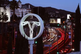 Zoe Buckman’s neon art installation depicting an abstracted uterus with fibreglass boxing gloves in place of ovaries on Sunset Boulevard in Los Angeles