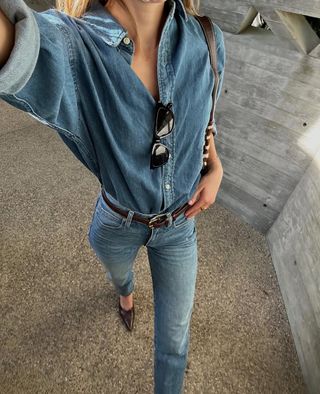 woman wearing denim button-down shirt and jeans with stiletto heels