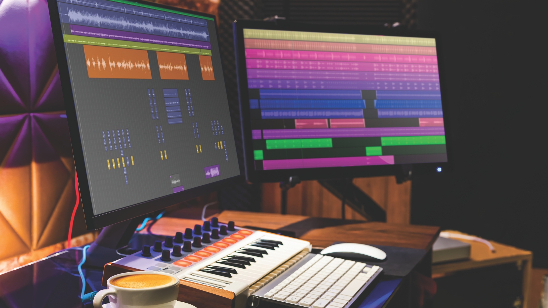 A studio setup with MIDI keyboard and multiple screens