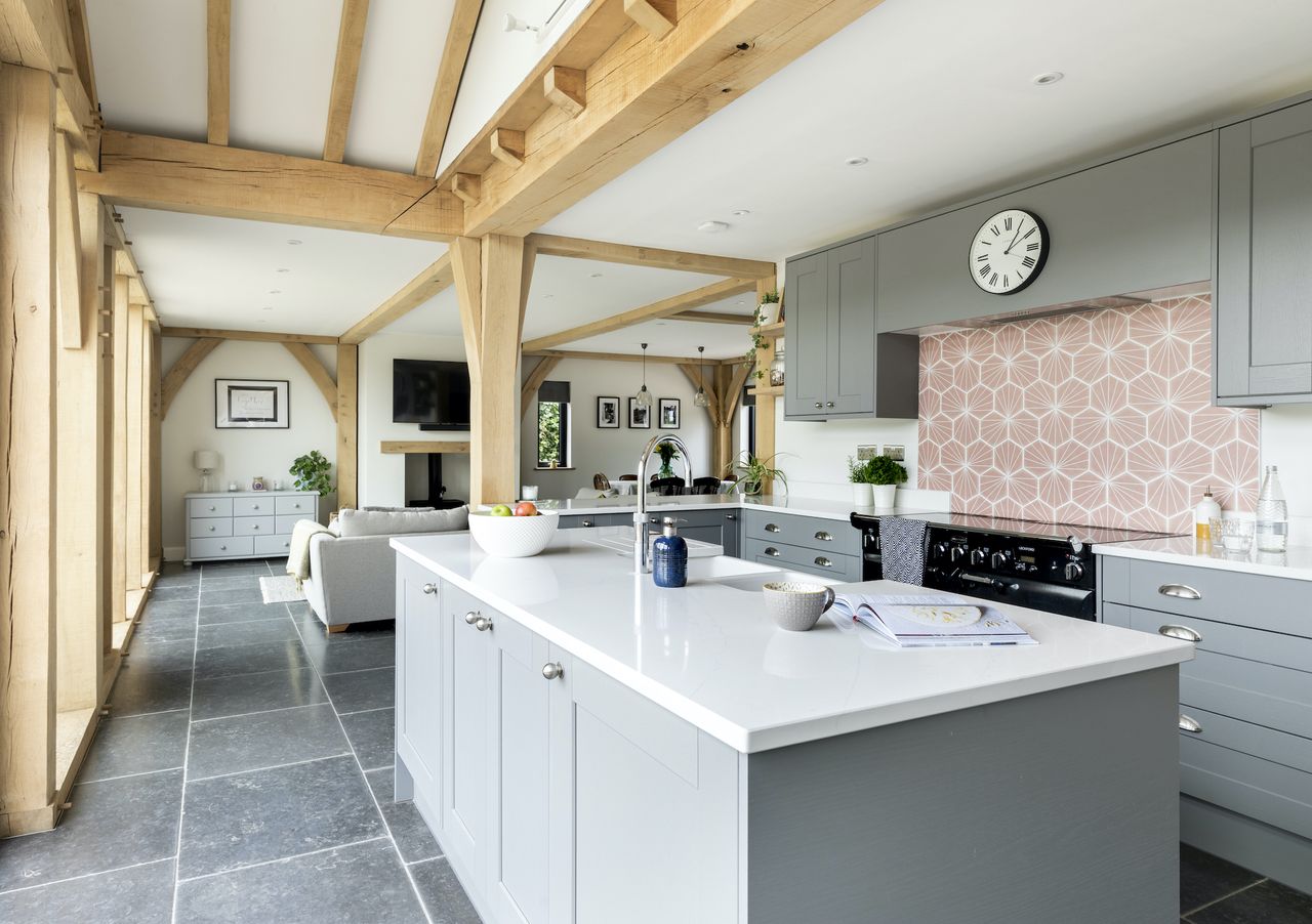 The Fairford Slate Grey Howdens&rsquo; kitchen contrasts with a hardwearing dark grey limestone flooring from Doga Natural Stone
