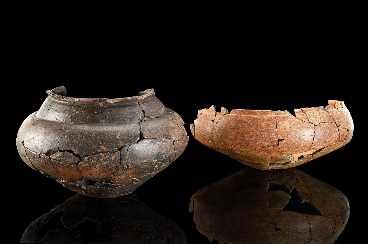 Two ceramic bowls against a black background.