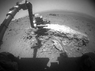 NASA's Mars Exploration Rover Opportunity used its front hazard-avoidance camera to take this picture showing the rover's arm extended toward a light-toned rock, "Tisdale 2," during the 2,695th Martian day, or sol, of the rover's work on Mars (Aug. 23, 2011).
