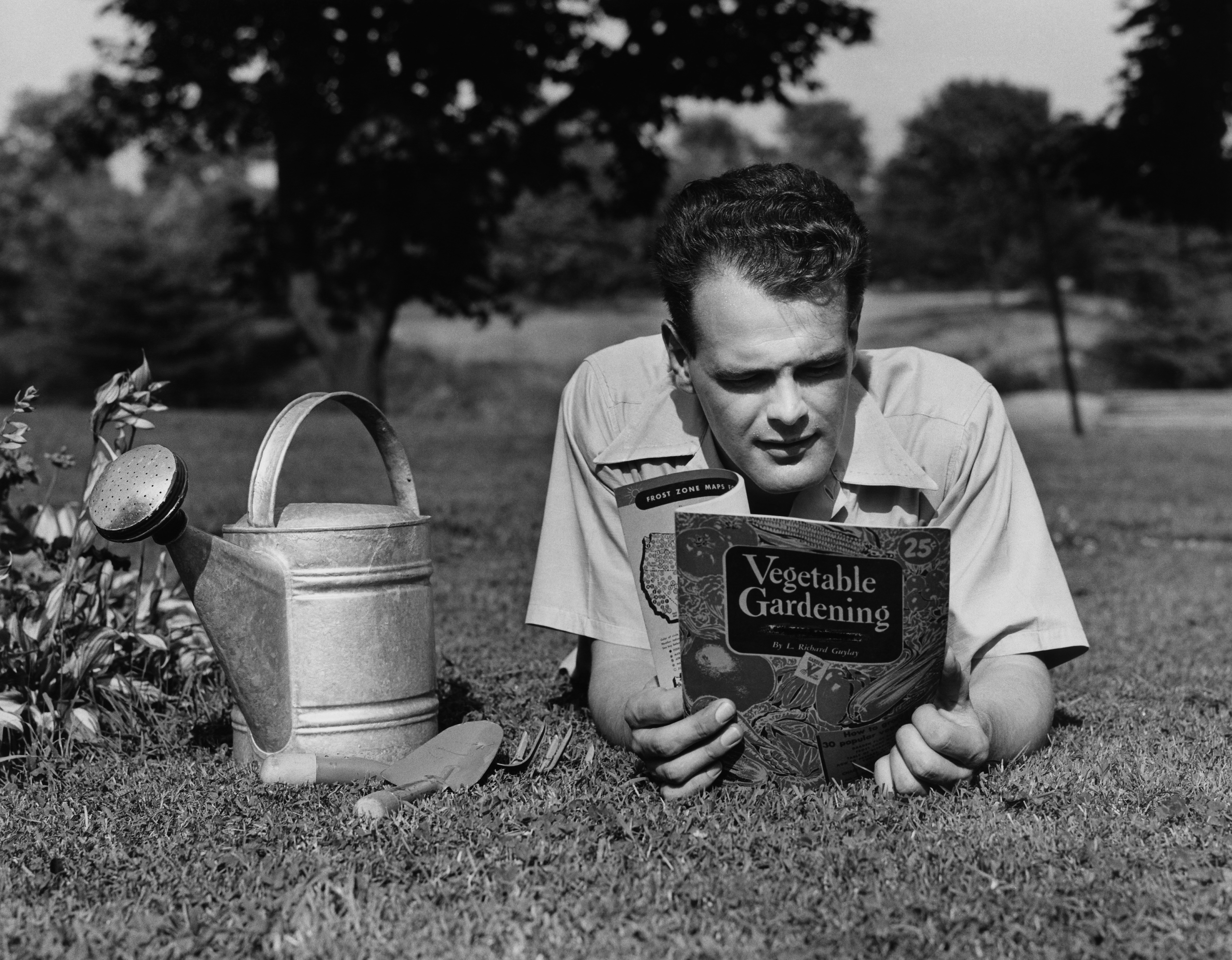 A man reads a vintage gardening book 