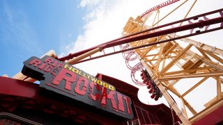 Press Photo of the sign and the giant launch of the red and yellow Hollywood Rip Ride Rockit coaster before its closing in August of 2025.