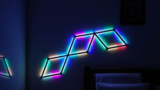 Nanoleaf Lines in rainbow lights attached to a wall