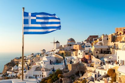 Oia Sunset and Greek Flag, Santorini, Greece