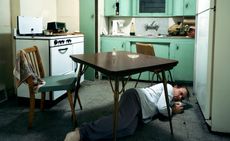 man on floor under table