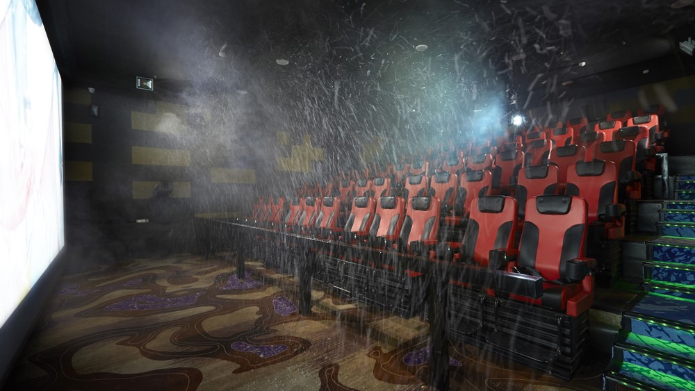 An empty cinema with water spraying from the walls and ceiling.