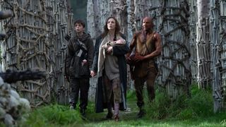 Spike, Isla, and Doctor Kelson walking through a wooded area in 28 Years Later