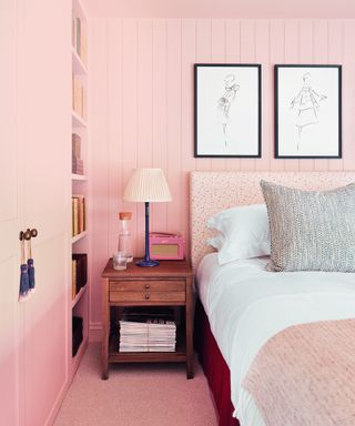 pink bedroom with pink paneling, pink shelving and pink patterned headboard