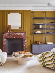 a caramel brown color living room with a red marble fireplace