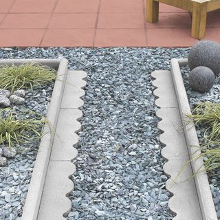 concrete patio with edging and stones on path