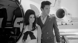 Newlyweds Elvis and Priscilla Presley, who met while Elvis was in the Army, prepare to board their private jet 