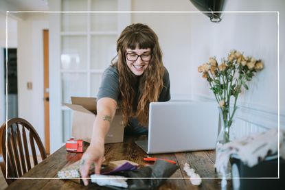 Woman working from home prepares shipment