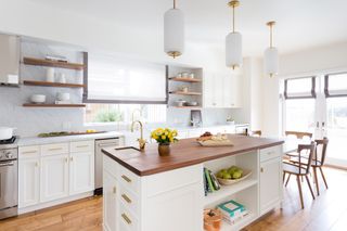 split level kitchen island in white kitchen by Amy Skar Design