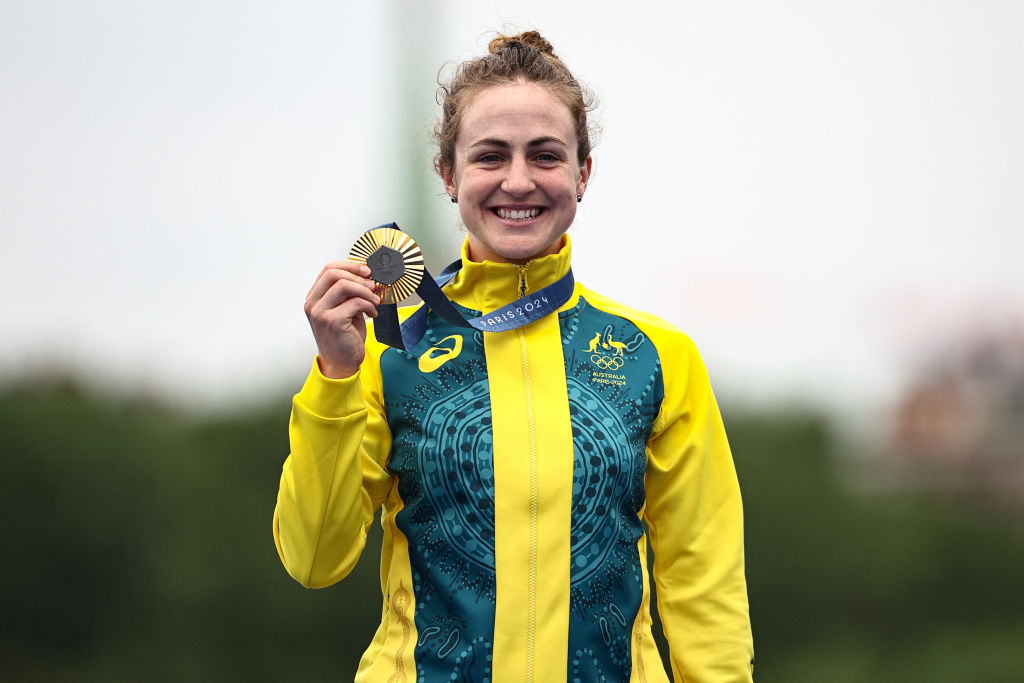 Australia's Grace Brown celebrates with her gold medal on the podium during the medal ceremony for the women's road cycling individual time trial during the Paris 2024 Olympic Games in Paris, on July 27, 2024. (Photo by Anne-Christine POUJOULAT / AFP)