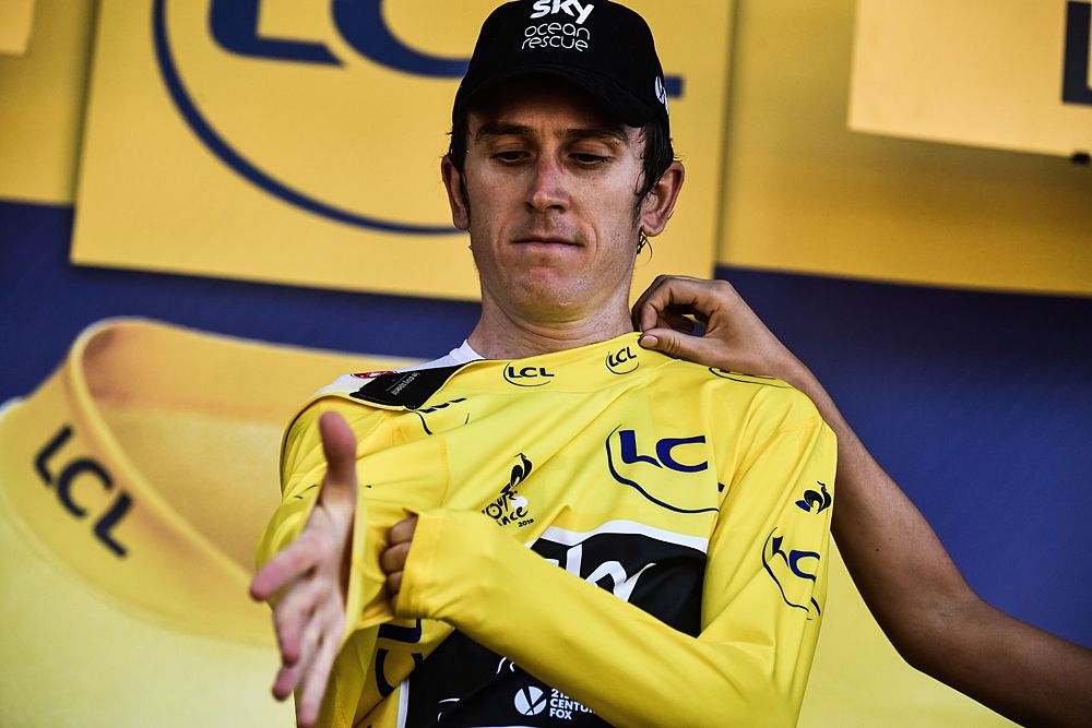 Geraint Thomas (Team Sky) puts on the yellow jersey after stage 16