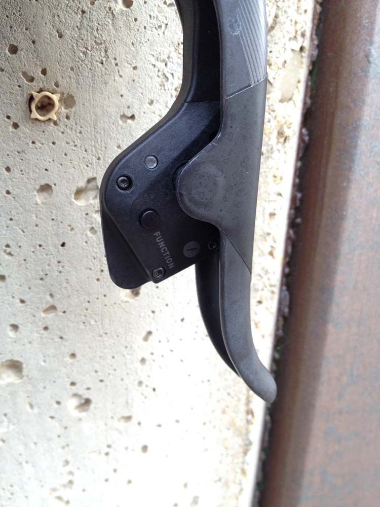 Shifts are performed by a single, one-stage button activated by moving the smaller lever behind the brake lever. Push on one lever's shift button to move the rear derailleur in one direction, or push the button on the other lever to move the chain in the opposite direction