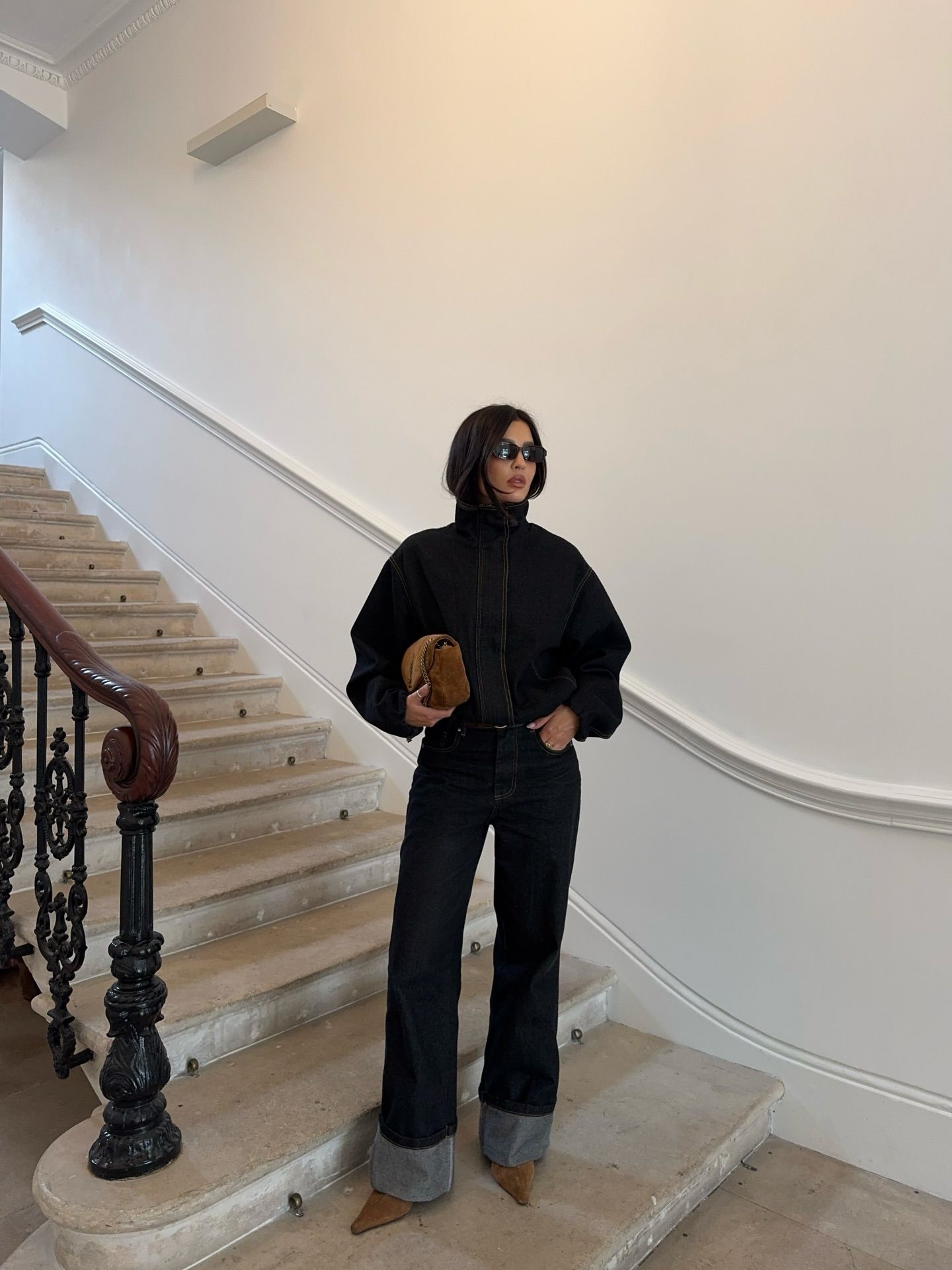 Influencer Emma Milton wearing indigo jeans with tan suede boots.