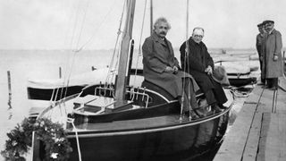 Einstein standing on his sailboat