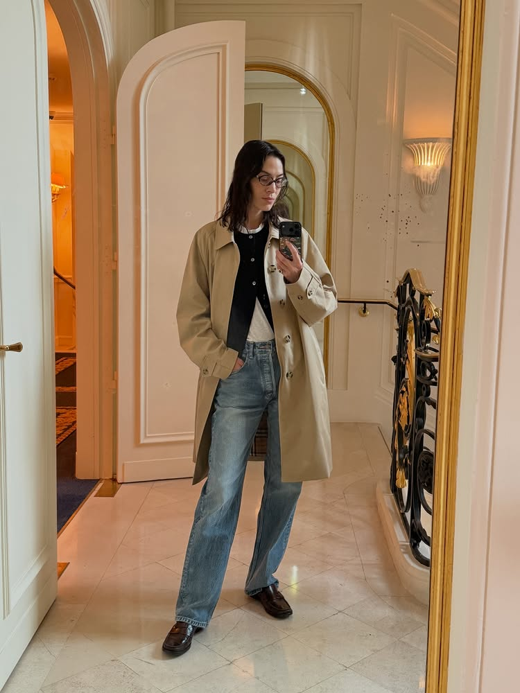 An image of @alexachung wearing blue jeans with brown loafers whilst in Paris.